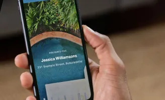 Person holding a smartphone displaying a personalised property report, with a pool image on screen.